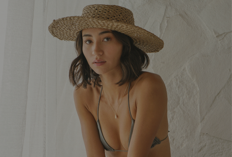 Miami fashion blogger and model Olivia Pascale in summer straw hat and grey bikini top