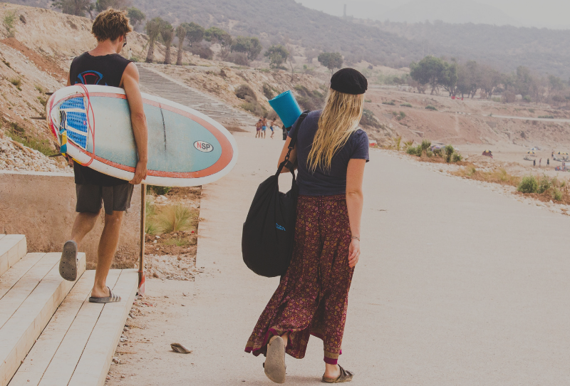 Surfers heading to the beach to stay active