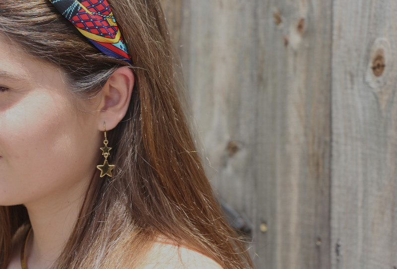 Fashion blogger in gold star earrings and cute colorful headband