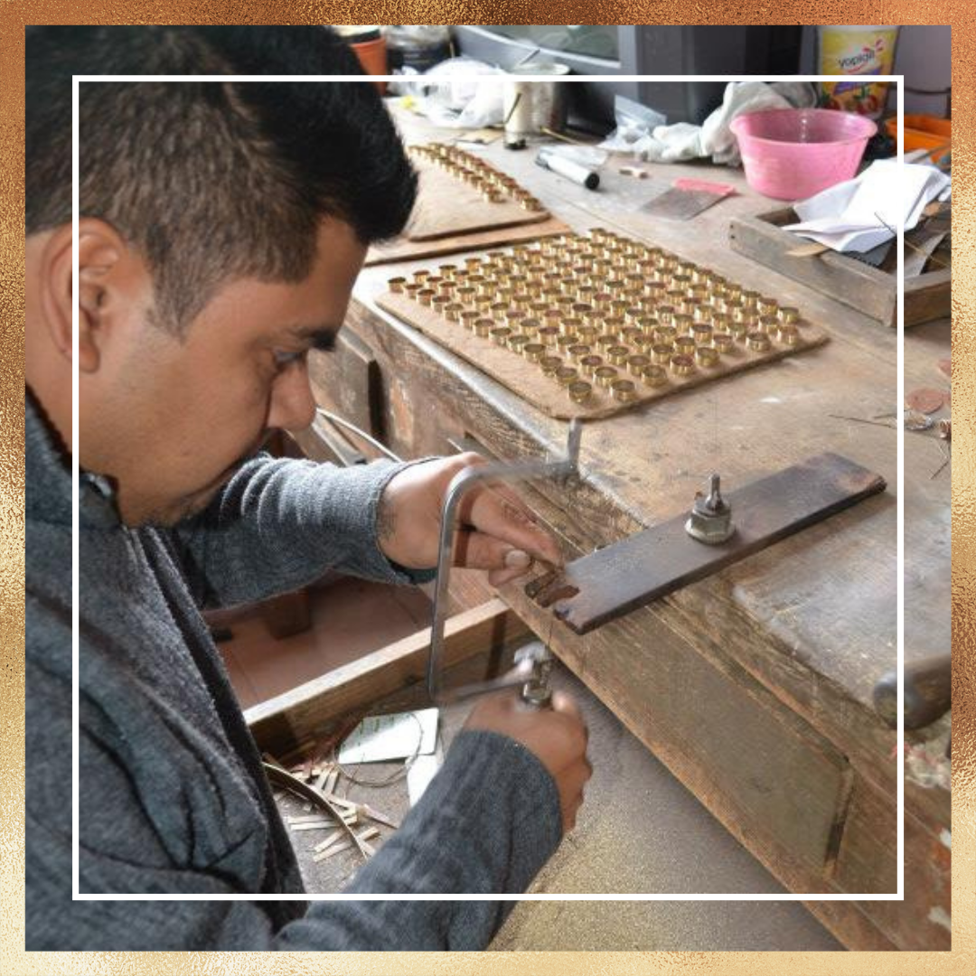 Worker making solid alchemia into pieces